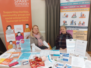 Photograph of two women hosting information stands for Spark Somerset and Somerset Carers