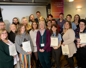 Photo of newly qualified learners with their certificates at the Somerset Youth Work Alliance event.
